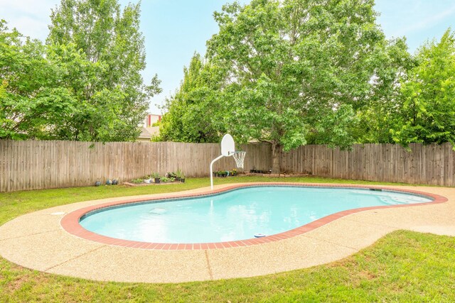 view of swimming pool featuring a fenced in pool, a fenced backyard, and a yard