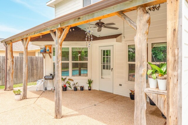 view of patio / terrace featuring a ceiling fan and fence