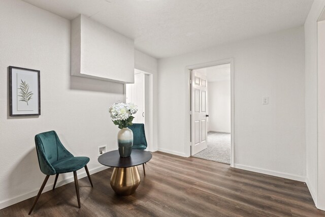 living area with baseboards and wood finished floors