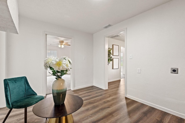 interior space featuring baseboards, dark wood-type flooring, and visible vents