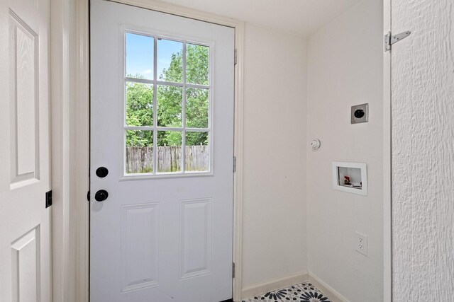 doorway to outside with baseboards