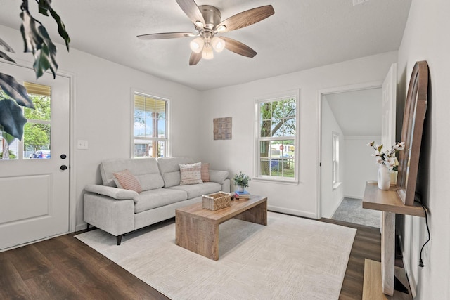living area with a wealth of natural light and dark wood-type flooring