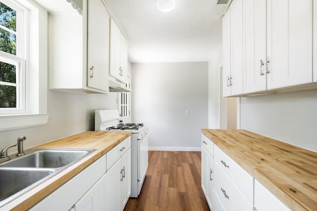 2224 Tisinger Ave, Dallas, TX 75228 - kitchen featuring under cabinet range hood, white gas range, butcher block countertops, and a sink