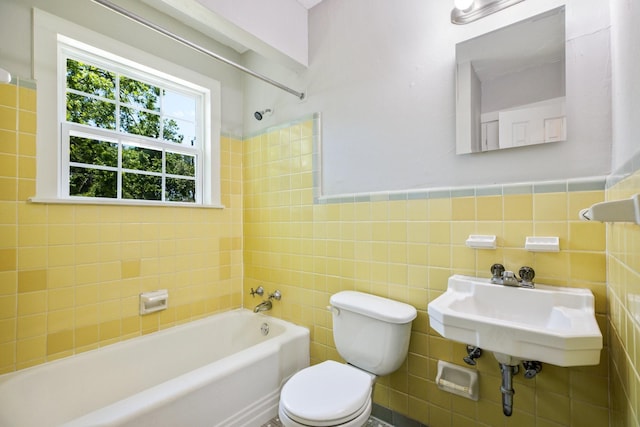 2224 Tisinger Ave, Dallas, TX 75228 - bathroom with a sink, shower / bathtub combination, toilet, tile walls, and wainscoting