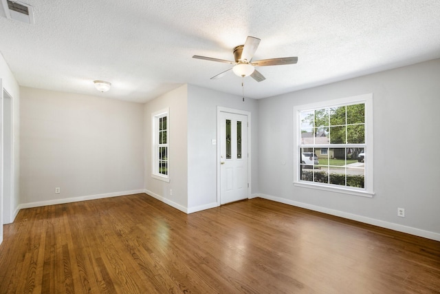 2224 Tisinger Ave, Dallas, TX 75228 - empty room featuring a textured ceiling, baseboards, visible vents, wood finished floors, and ceiling fan