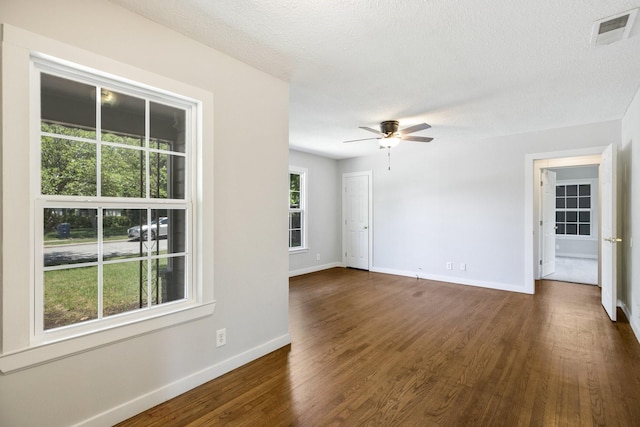 2224 Tisinger Ave, Dallas, TX 75228 - empty room with a ceiling fan, a textured ceiling, visible vents, baseboards, and dark wood-style floors