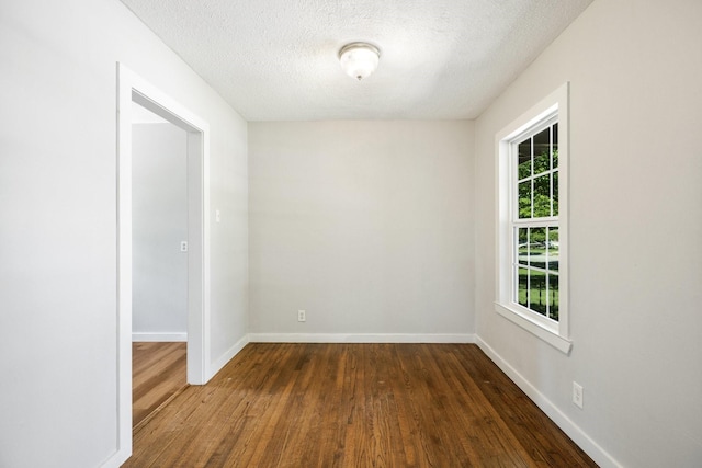 2224 Tisinger Ave, Dallas, TX 75228 - unfurnished room featuring a textured ceiling, baseboards, and dark wood finished floors