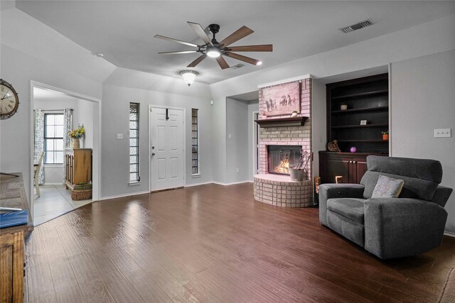620 Linda Dr, Burleson, TX 76028 - living room with a ceiling fan, a brick fireplace, wood finished floors, and visible vents