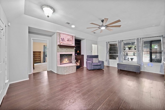 620 Linda Dr, Burleson, TX 76028 - living area featuring dark wood-style floors, ceiling fan, a fireplace, baseboards, and visible vents