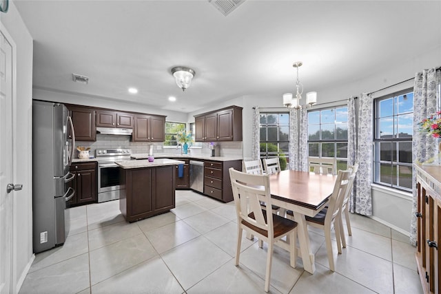 620 Linda Dr, Burleson, TX 76028 - kitchen featuring light countertops, visible vents, dark brown cabinetry, appliances with stainless steel finishes, and a notable chandelier