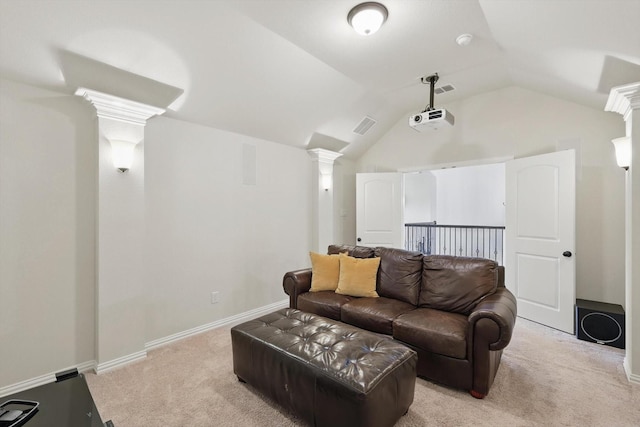 cinema featuring visible vents, light carpet, decorative columns, and lofted ceiling