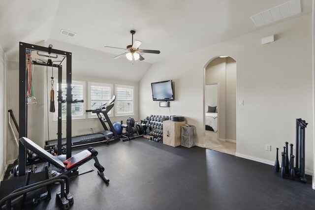 exercise area featuring visible vents, a ceiling fan, arched walkways, and vaulted ceiling