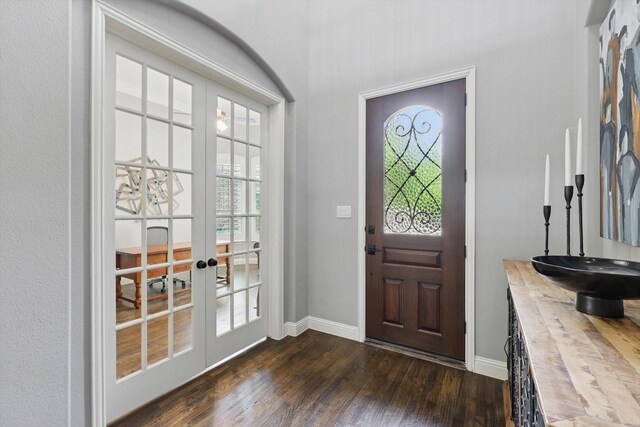 entrance foyer featuring baseboards, dark wood-style floors, and french doors