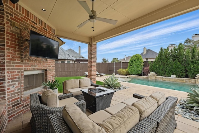 view of patio / terrace with a fenced backyard, an outdoor living space with a fire pit, a fenced in pool, and a ceiling fan