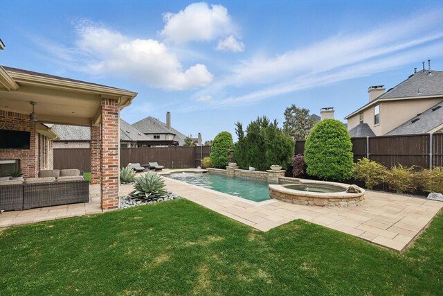 view of swimming pool featuring a lawn, a pool with connected hot tub, a patio area, a fenced backyard, and outdoor lounge area