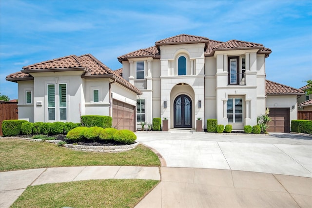 13508 Balint Ln, Frisco, TX 75035 - mediterranean / spanish house with stucco siding, driveway, a tiled roof, and a garage