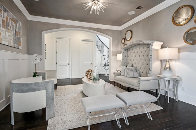 13508 Balint Ln, Frisco, TX 75035 - living room with dark wood-style floors, arched walkways, a notable chandelier, stairway, and crown molding