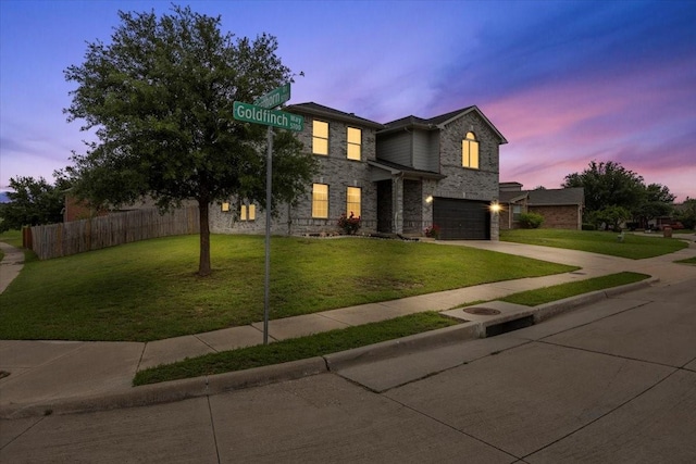 5712 Goldfinch Way, Dallas, TX 75249 - traditional home with driveway, a garage, fence, a yard, and stone siding