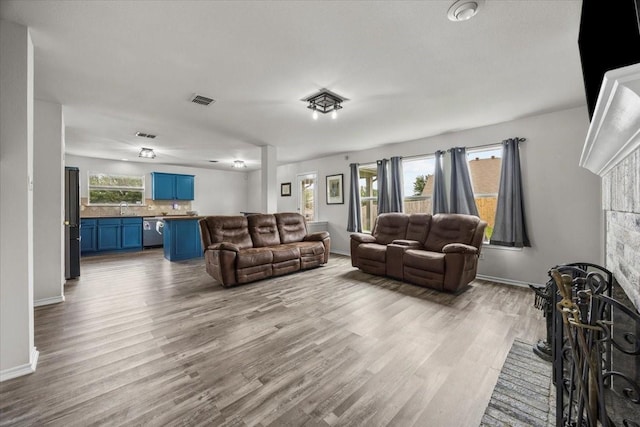 5712 Goldfinch Way, Dallas, TX 75249 - living room with baseboards, wood finished floors, and visible vents