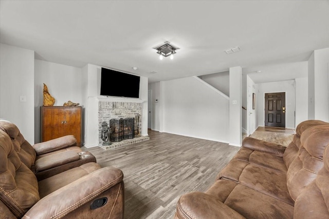 5712 Goldfinch Way, Dallas, TX 75249 - living area featuring visible vents, a brick fireplace, and wood finished floors