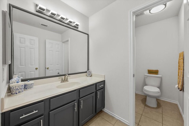 5712 Goldfinch Way, Dallas, TX 75249 - bathroom with tile patterned flooring, vanity, toilet, baseboards, and visible vents