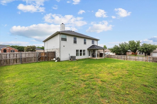 5712 Goldfinch Way, Dallas, TX 75249 - rear view of property with a fenced backyard, a chimney, a patio area, a lawn, and central air condition unit