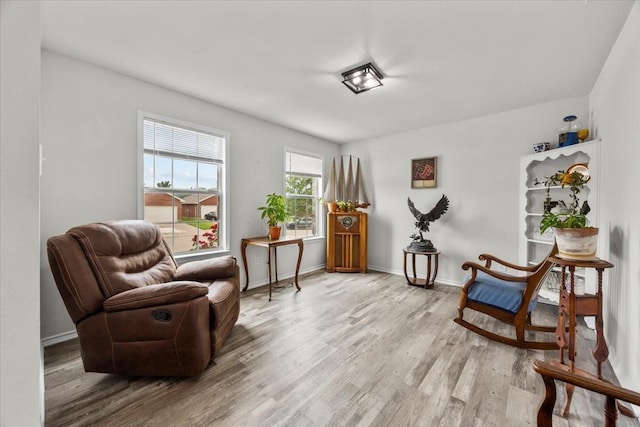 5712 Goldfinch Way, Dallas, TX 75249 - sitting room featuring light wood-style floors and baseboards