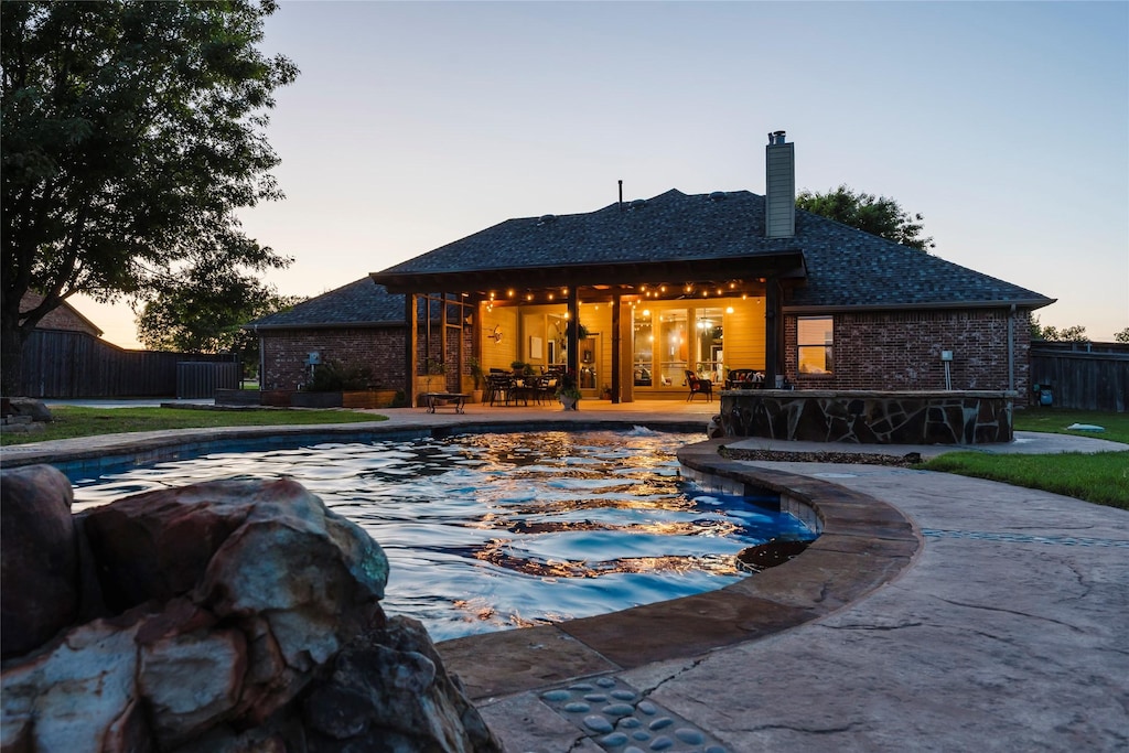 12042 N Emerald Ranch Ln, Forney, TX 75126 - pool at dusk featuring fence and a patio