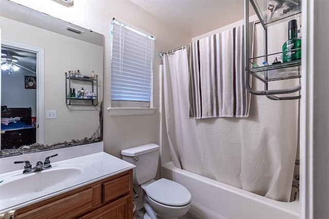 bathroom with vanity, toilet, visible vents, a ceiling fan, and shower / bath combination with curtain