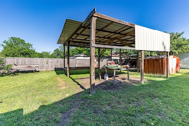 view of yard featuring fence and an outbuilding