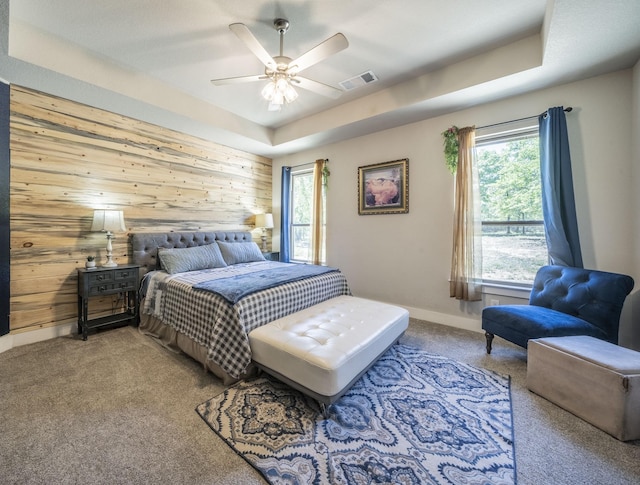2033 Antler Loop, Poolville, TX 76487 - bedroom with wooden walls, carpet flooring, a raised ceiling, and a ceiling fan