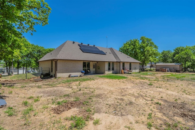 2033 Antler Loop, Poolville, TX 76487 - back of house with solar panels and a patio area