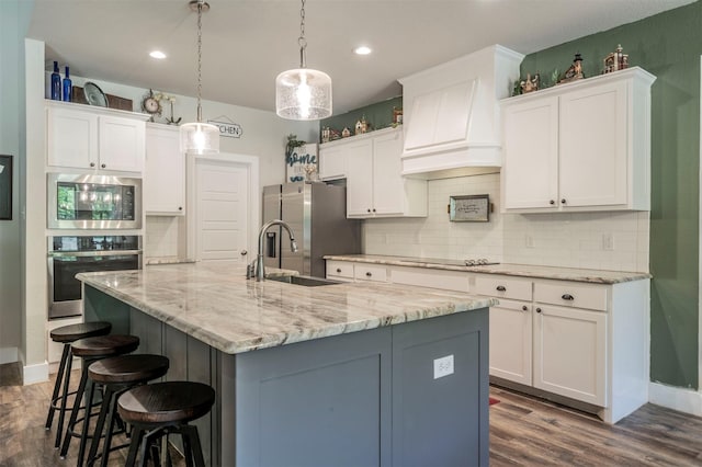2033 Antler Loop, Poolville, TX 76487 - kitchen featuring appliances with stainless steel finishes, white cabinetry, dark wood-style flooring, a kitchen bar, and recessed lighting