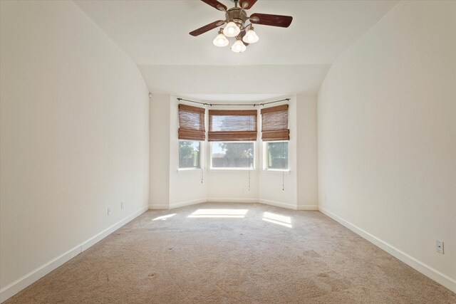 unfurnished room featuring vaulted ceiling, carpet floors, and ceiling fan