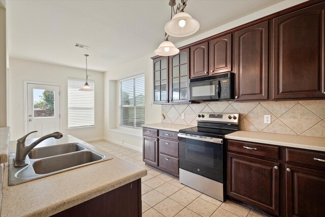 403 Connemara Trl, Celina, TX 75009 - kitchen featuring black microwave, stainless steel electric range, a sink, decorative light fixtures, and light tile patterned flooring