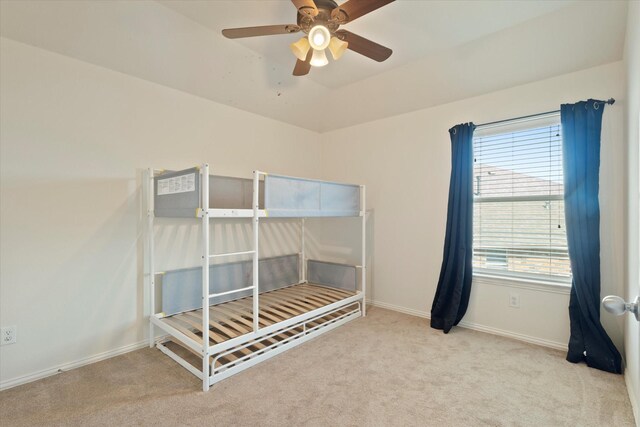 bedroom featuring lofted ceiling, baseboards, carpet flooring, and ceiling fan