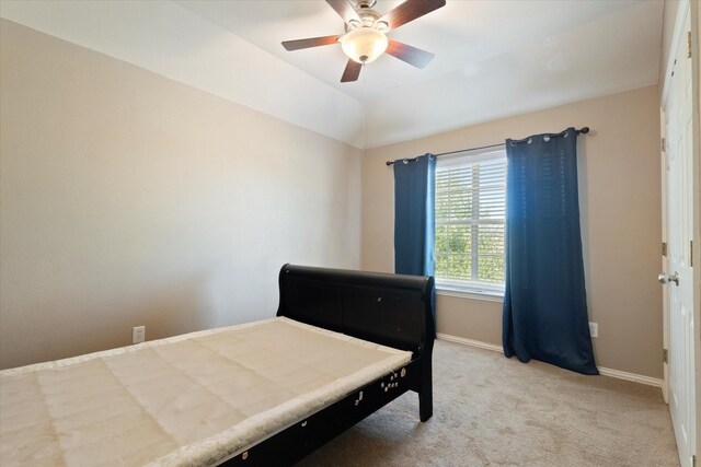 carpeted bedroom with baseboards and a ceiling fan