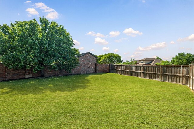 view of yard with a fenced backyard