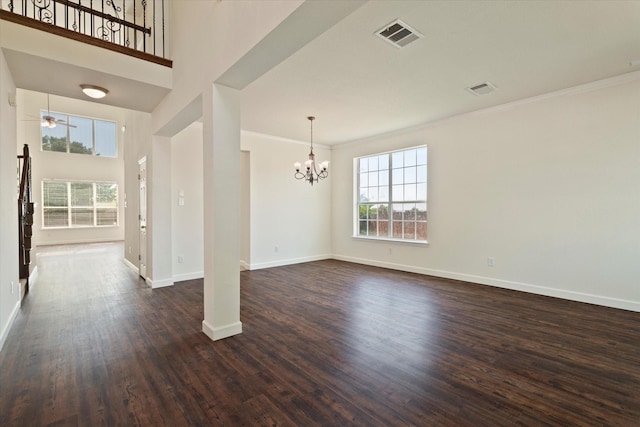 unfurnished dining area featuring visible vents, baseboards, dark wood-style flooring, and an inviting chandelier