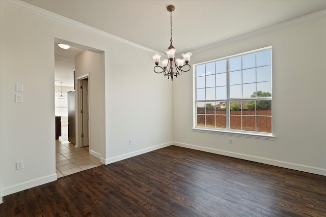 403 Connemara Trl, Celina, TX 75009 - spare room with a chandelier, wood finished floors, ornamental molding, and baseboards