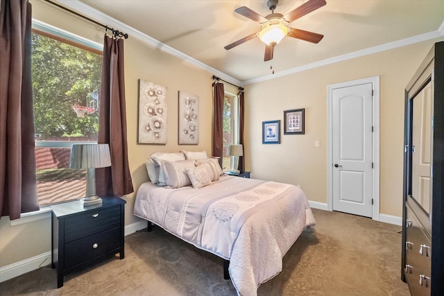 carpeted bedroom with ceiling fan, baseboards, and ornamental molding