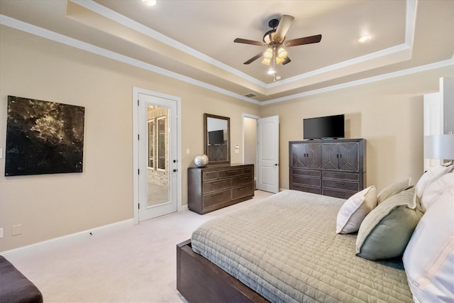 bedroom with ornamental molding, a raised ceiling, and access to exterior