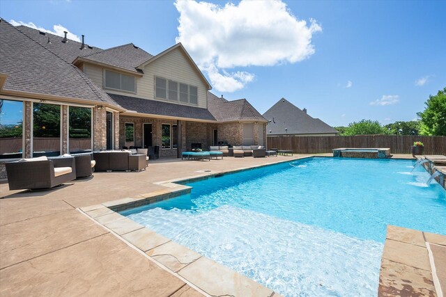 view of pool with an outdoor hangout area, a fenced backyard, a pool with connected hot tub, and a patio area