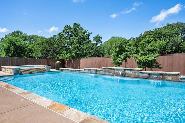 view of swimming pool featuring a fenced backyard and a pool with connected hot tub