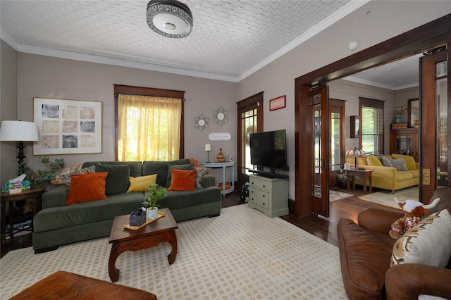 living room featuring wood finished floors and crown molding