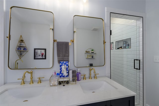 bathroom featuring a shower with shower door, double vanity, and a sink