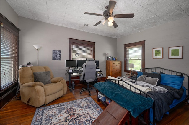 bedroom featuring an ornate ceiling, wood finished floors, visible vents, and ceiling fan