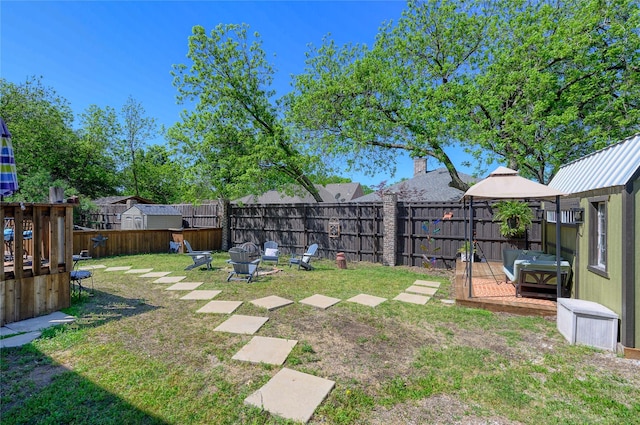 view of yard featuring a fire pit, a gazebo, and a fenced backyard