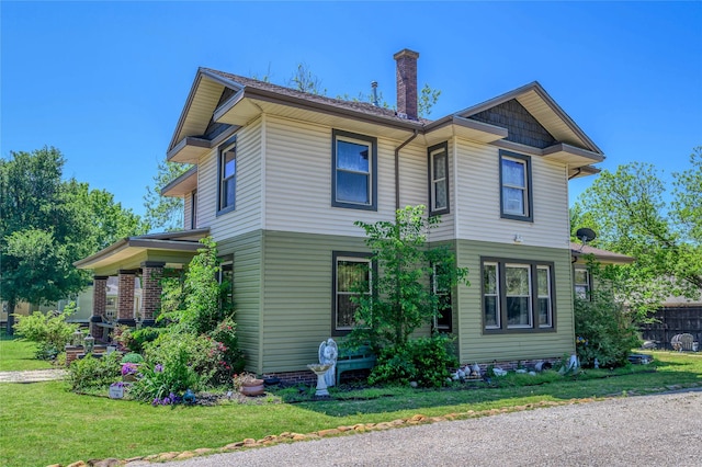 view of front of property with a front yard and a chimney