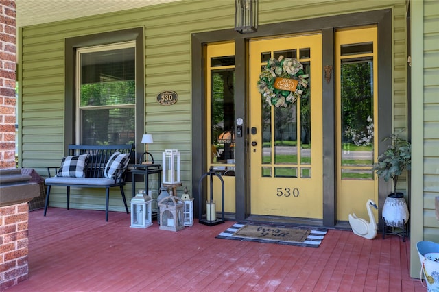 view of exterior entry with covered porch